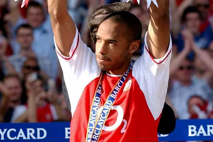 Arsenal's Thierry Henry celebrates with the Barclaycard Premiership trophy after their match against Leicester City at Arsenal's Highbury Stadium, London Saturday May 15 2004. 