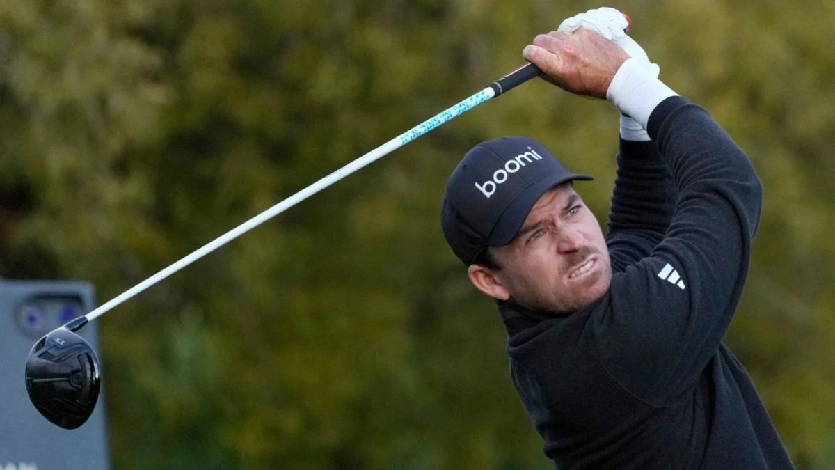Nick Taylor, of Canada, watches his tee shot on the fifth hole during the third round of the Phoenix Open