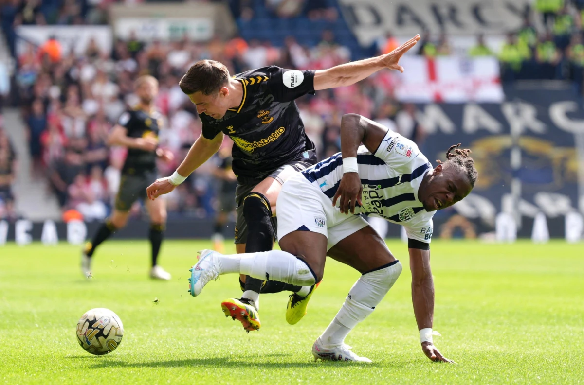 Southampton's Jan Bednarek and West Brom's Brandon Thomas-Asante battle for the ball in the play-off semi-final first leg
