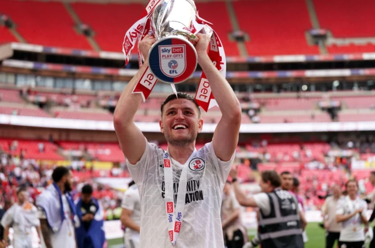 Laurence Maguire of Crawley Town celebrates the play-off final win