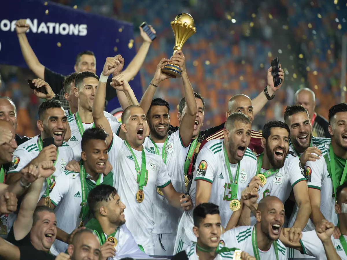 Riyad Mahrez of Algeria (c) holds aloft the trophy during the 2019 Africa Cup of Nations Finals Final football match between Senegal and Algeria at the Cairo International Stadium, Cairo, Egy