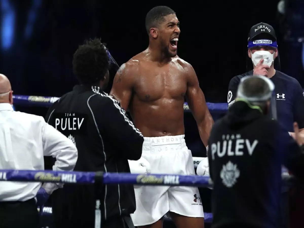 Anthony Joshua celebrates win over Kubrat Pulev
