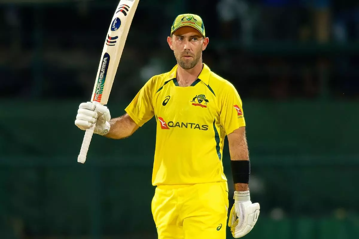 Australia's Glenn Maxwell raises his bat after scoring 50 runs