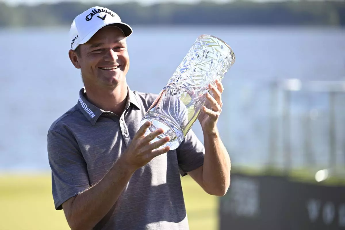 Britain's Dale Whitnell holds the trophy