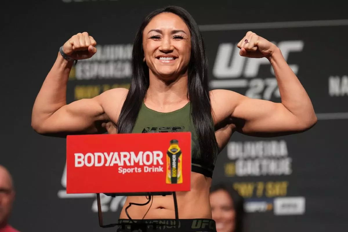 MMA Fighter Carla Esparza steps on the scale for the fans in attendance at Hyatt Regency for UFC 274 - May 2022