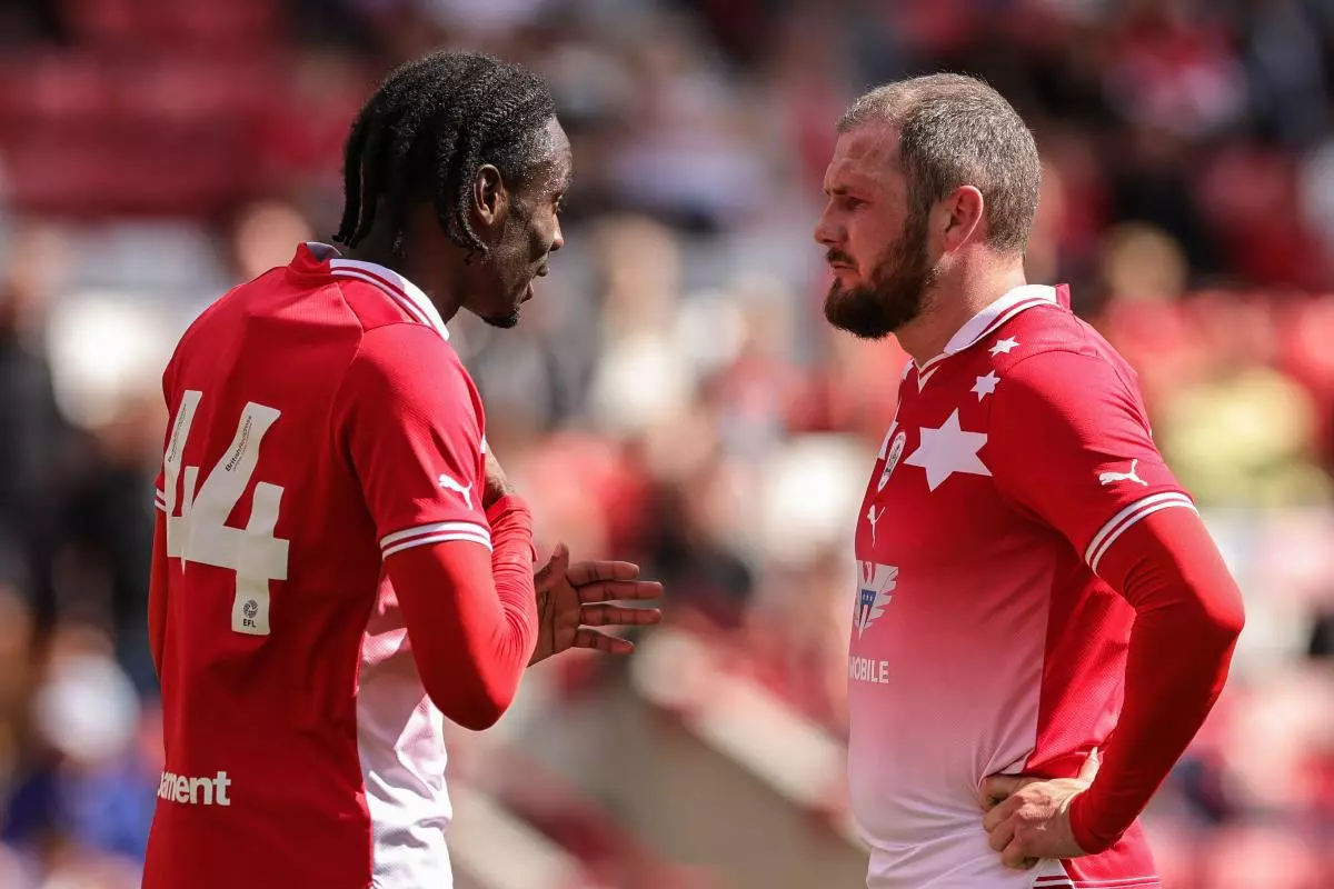 Devante Cole of Barnsley speaks to James Norwood 
