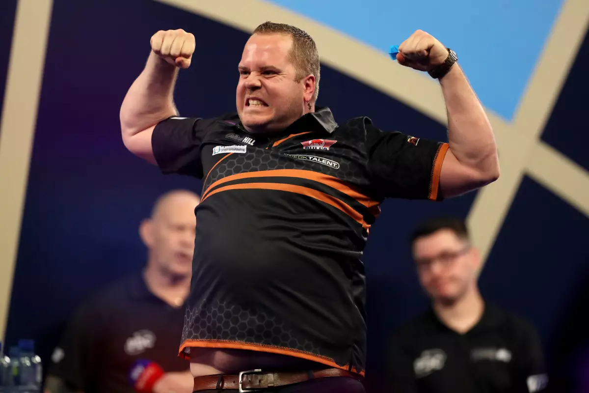 Dirk Van Duijvenbode celebrates against Ross Smith during day ten of the William Hill World Darts Championship at Alexandra Palace, London. 