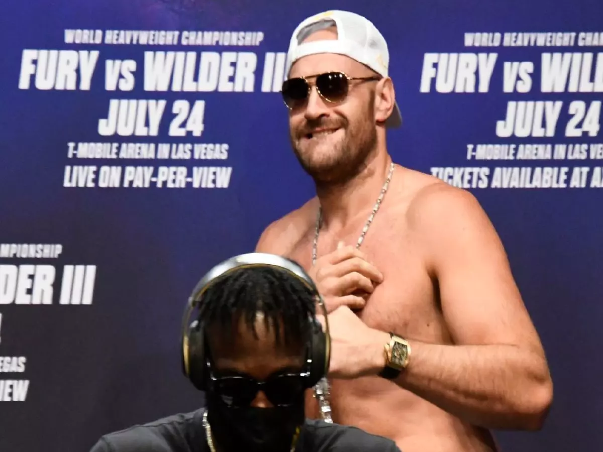 Tyson Fury jokes around but Deontay Wilder refuses to take his headphones off