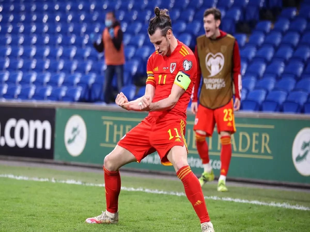 Gareth Bale celebrates their side's first goal of the game during the 2022 FIFA World Cup Qualifying match at Cardiff City Stadium, Wales. 