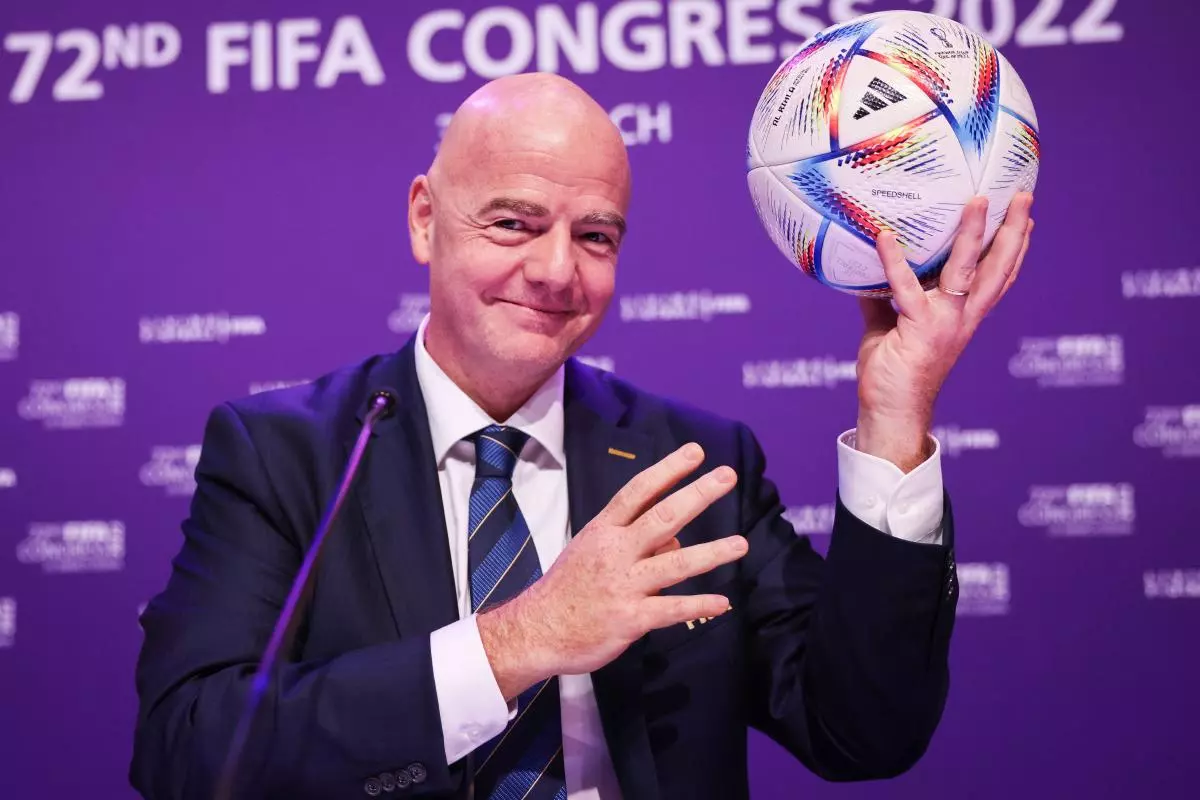 Fifa President Gianni Infantino holds the official match ball
