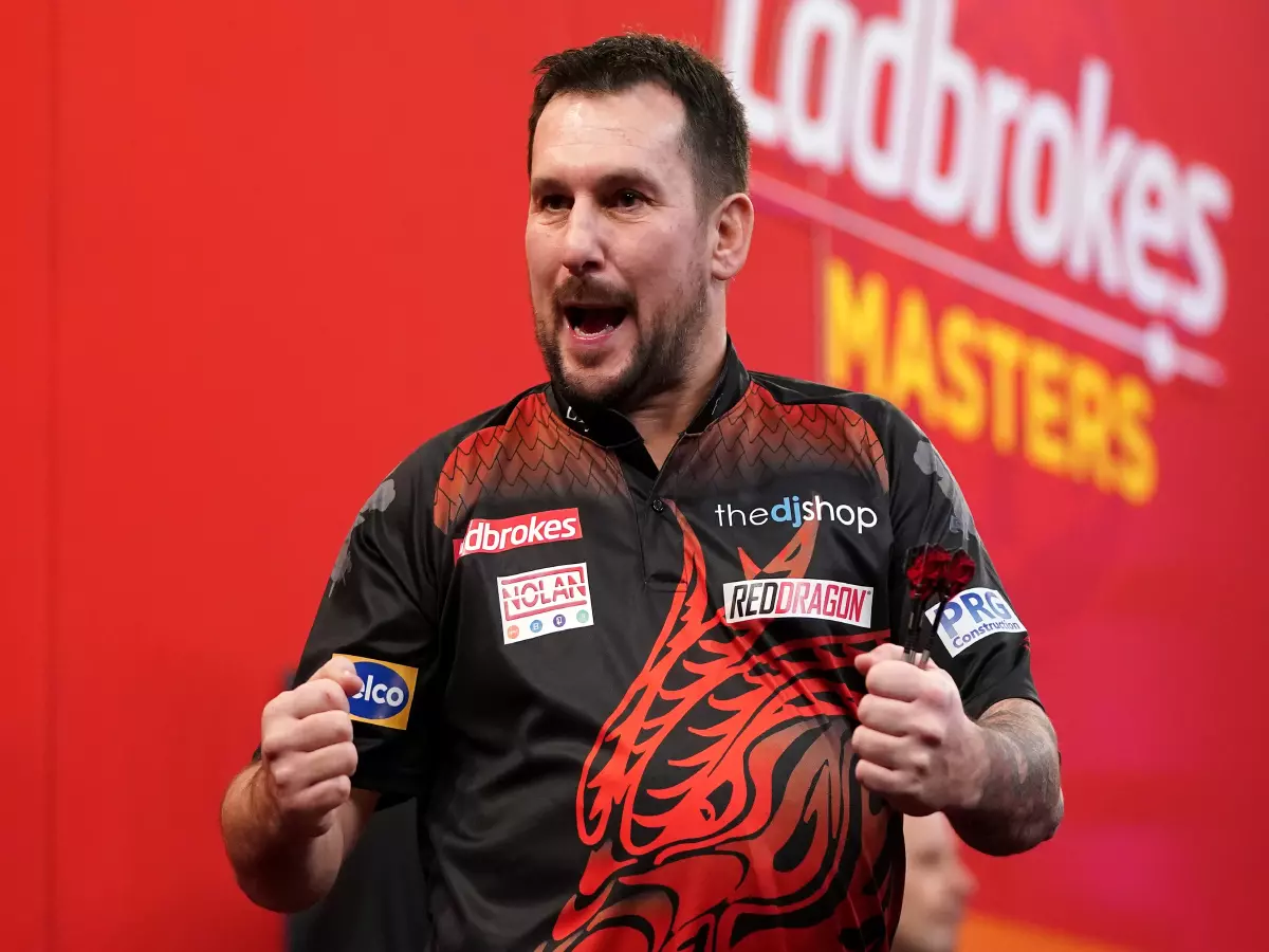 Jonny Clayton celebrates during day one of the Ladbrokes Masters 2021 tournament at the Marshall Arena, Milton Keynes