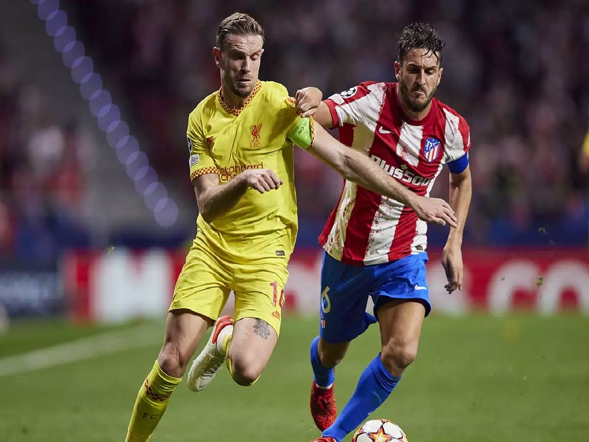 Jordan Henderson and Koke contest the ball
