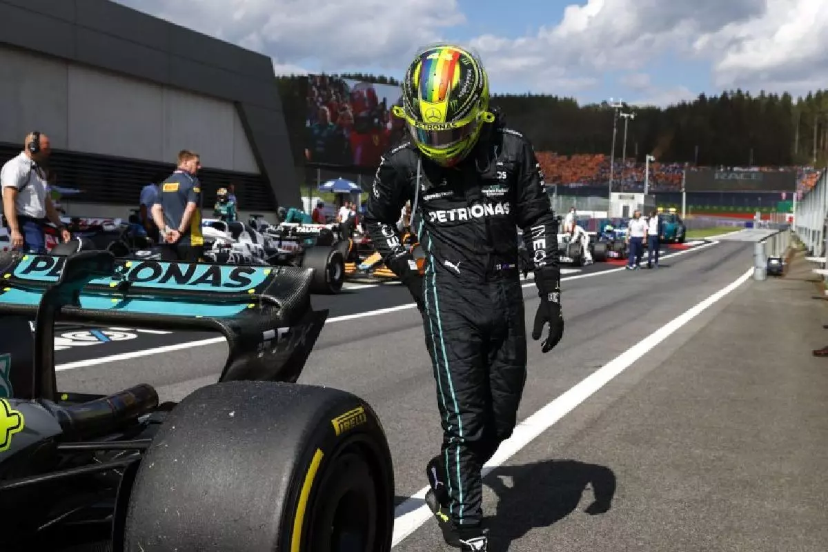 Lewis Hamilton looks at rear of W13