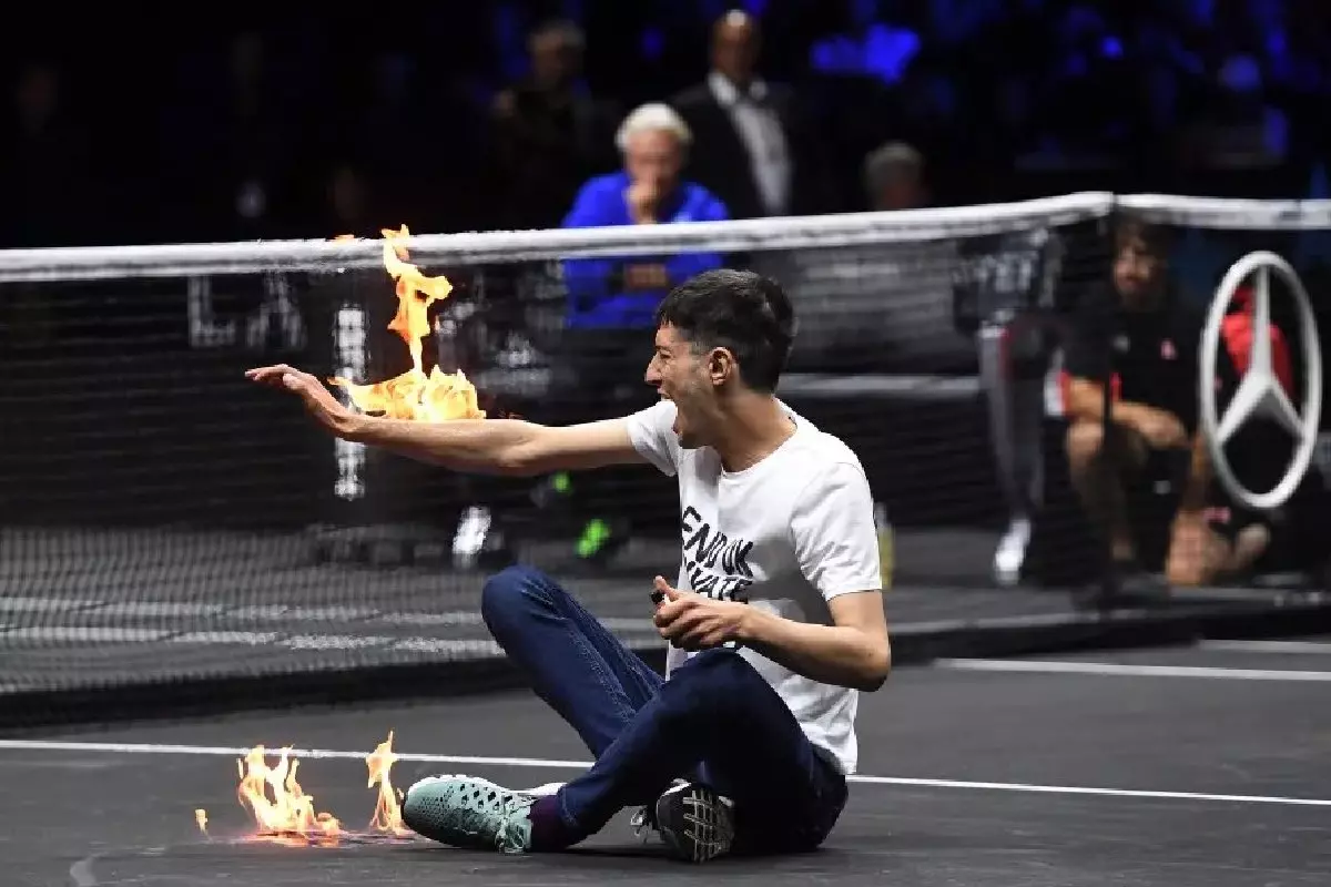 Protestor sets arm on fire