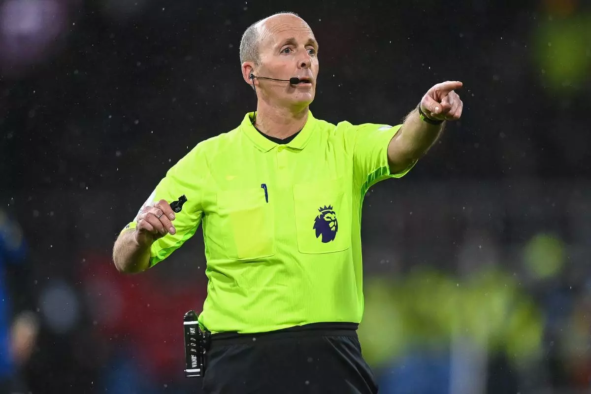 Referee Mike Dean gives instructions during the game