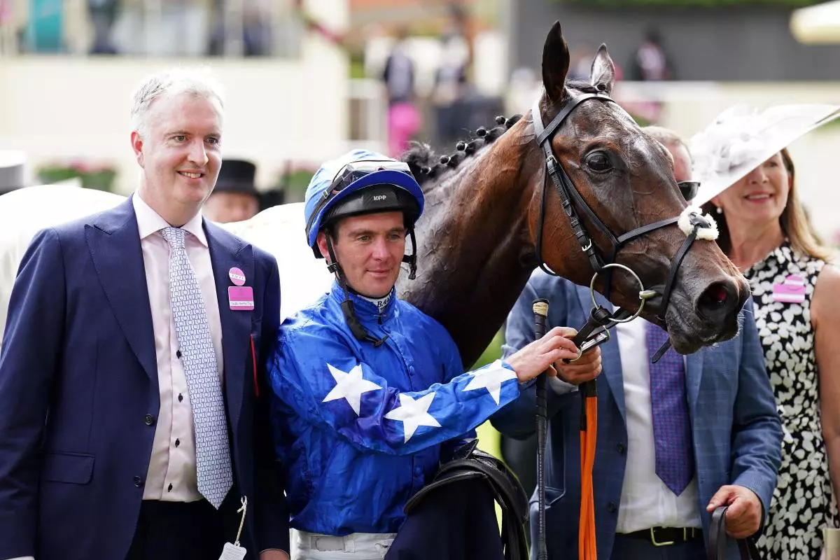 Jockey Gary Carroll (centre) celebrates after winning the Chesham Stakes with horse Snellen