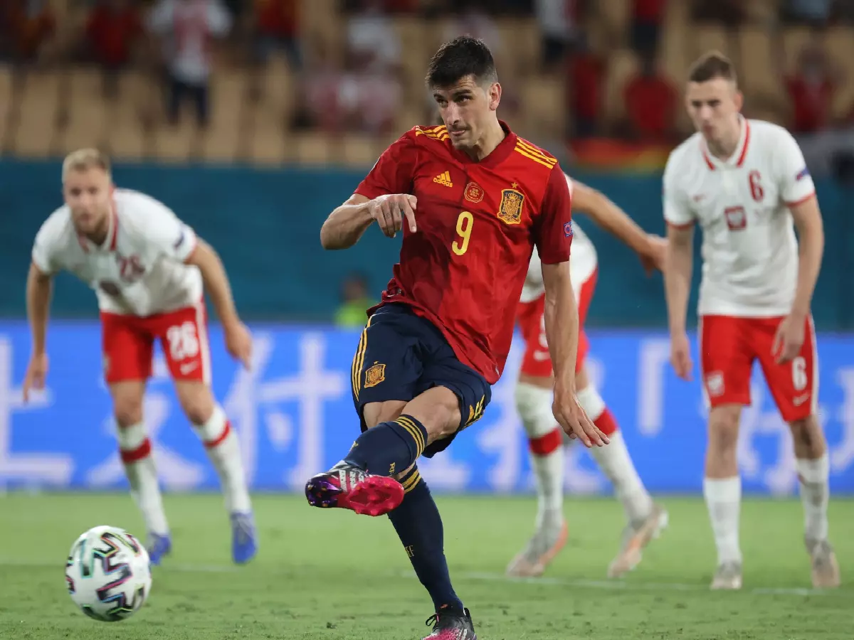Spain's Gerard Moreno takes a penalty that he won against Poland