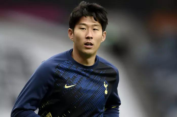A fan in the stands holds up a Tottenham Hotspur's Son Heung-min