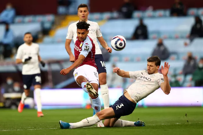 Aston Villa's Ollie Watkins (left) shoots under pressure from Manchester City's Ruben Dias (right) during the Premier League match at Villa Park, Birmingham.
