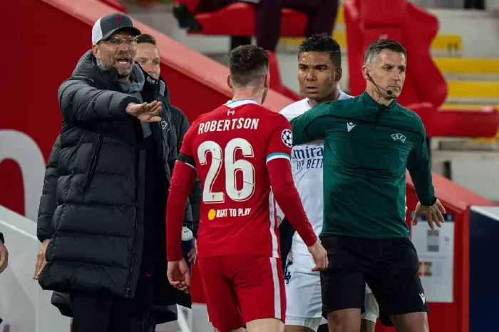 Andy Robertson confronts Casemiro after tackling James Milner