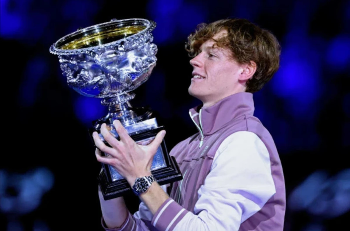 Jannik Sinner of Italy holds the Norman Brookes Challenge Cup aloft after defeating Daniil Medvedev - Jan 2023