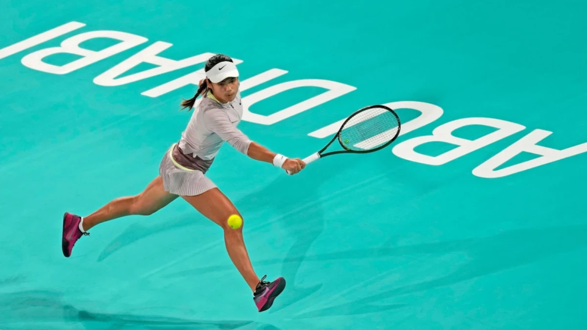 Emma Raducanu from Britain returns the ball to Marie Bouzkova of Czech Republic during a match of the Mubadala Abu Dhabi Open tennis tournament, in Abu Dhabi, United Arab Emirates