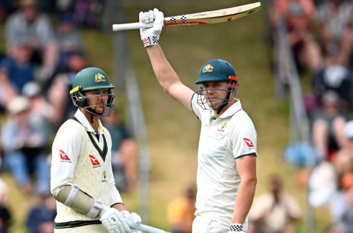 Australia'a Cameron Green, right, celebrates scoring 150 runs against New Zealand as teammate Josh Hazlewood watches on the second day of their cricket test match in Wellington, New Zealand