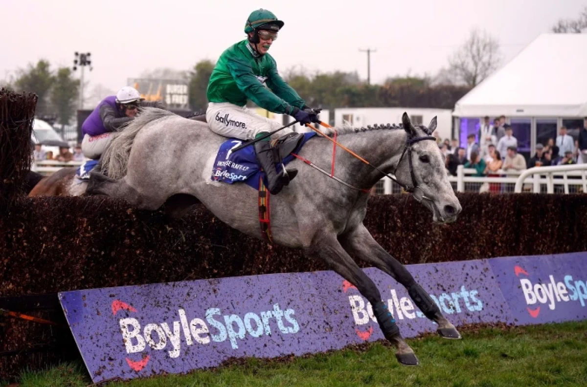 Intense Raffles ridden by jockey JJ Slevin clear a fence on their way to winning the Irish Grand National