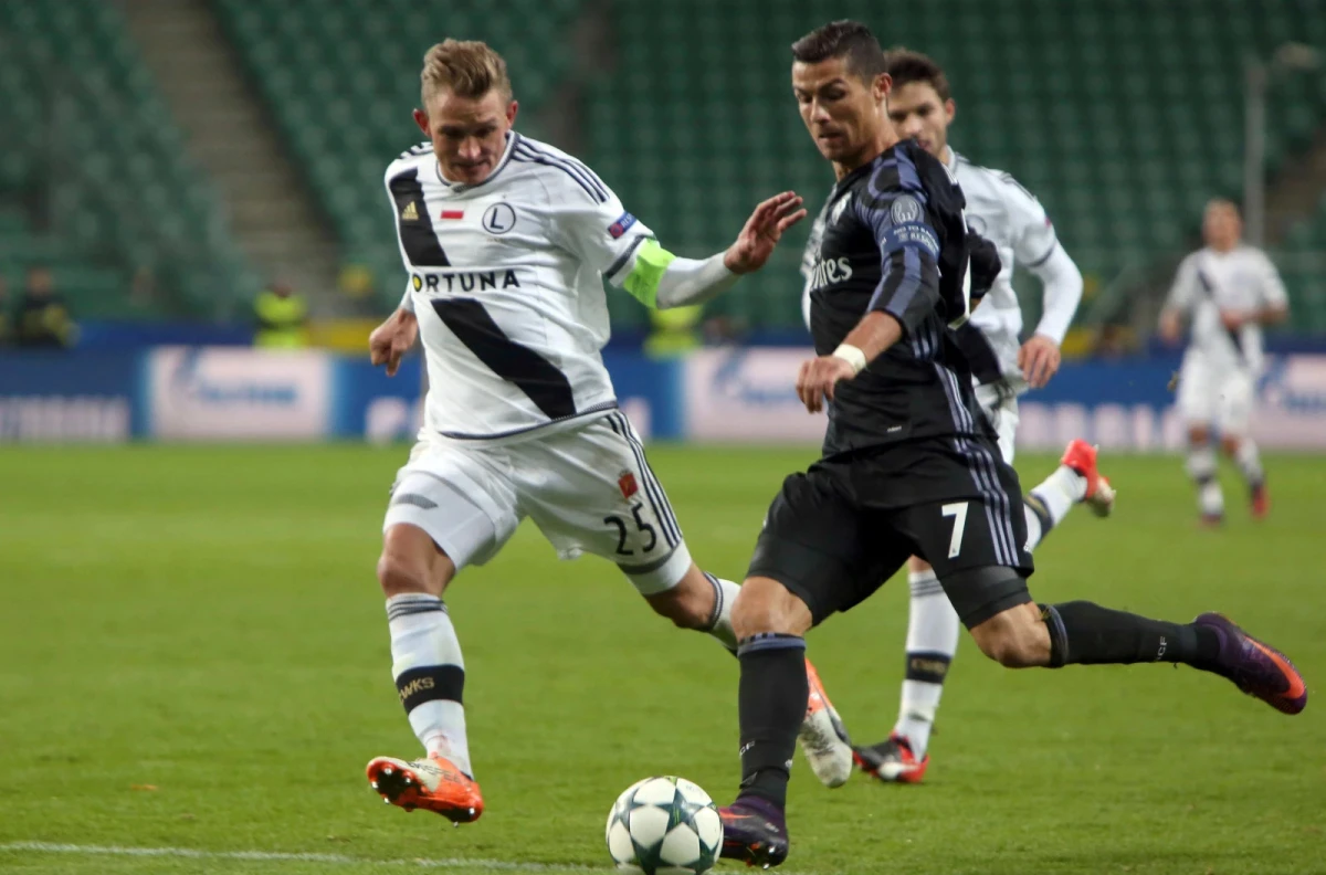 Legia's Jakub Rzezniczak against Cristiano Ronaldo