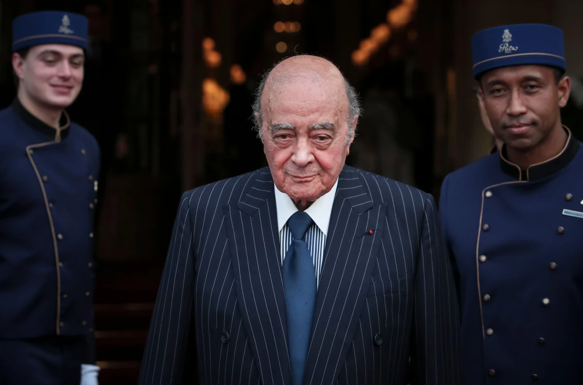 Mohammed Al Fayed poses with his hotel staff in Paris