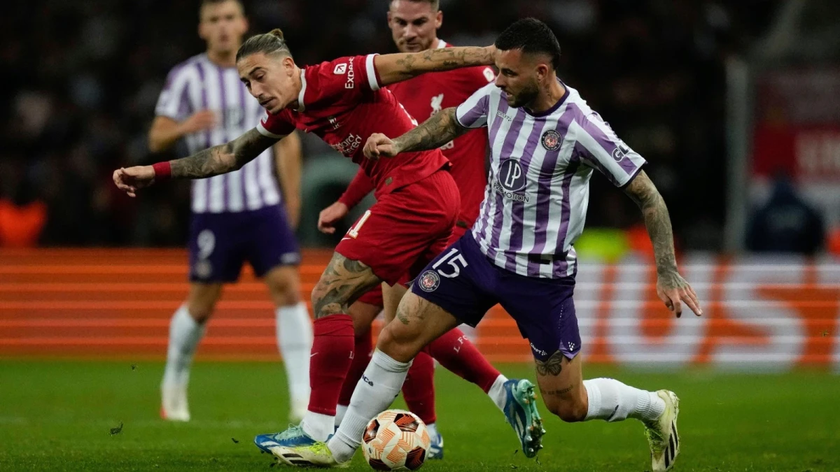 Toulouse's Aron Donnum and Liverpool's Kostas Tsimikas