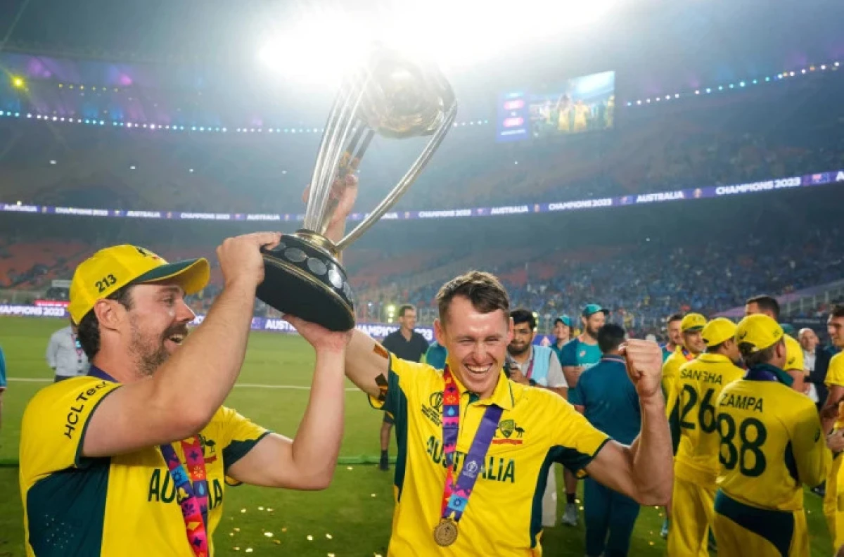 Australia's Travis Head, left, holds the trophy with teammate Marnus Labuschagne after Australia won the ICC Men's Cricket World Cup - Nov 2023