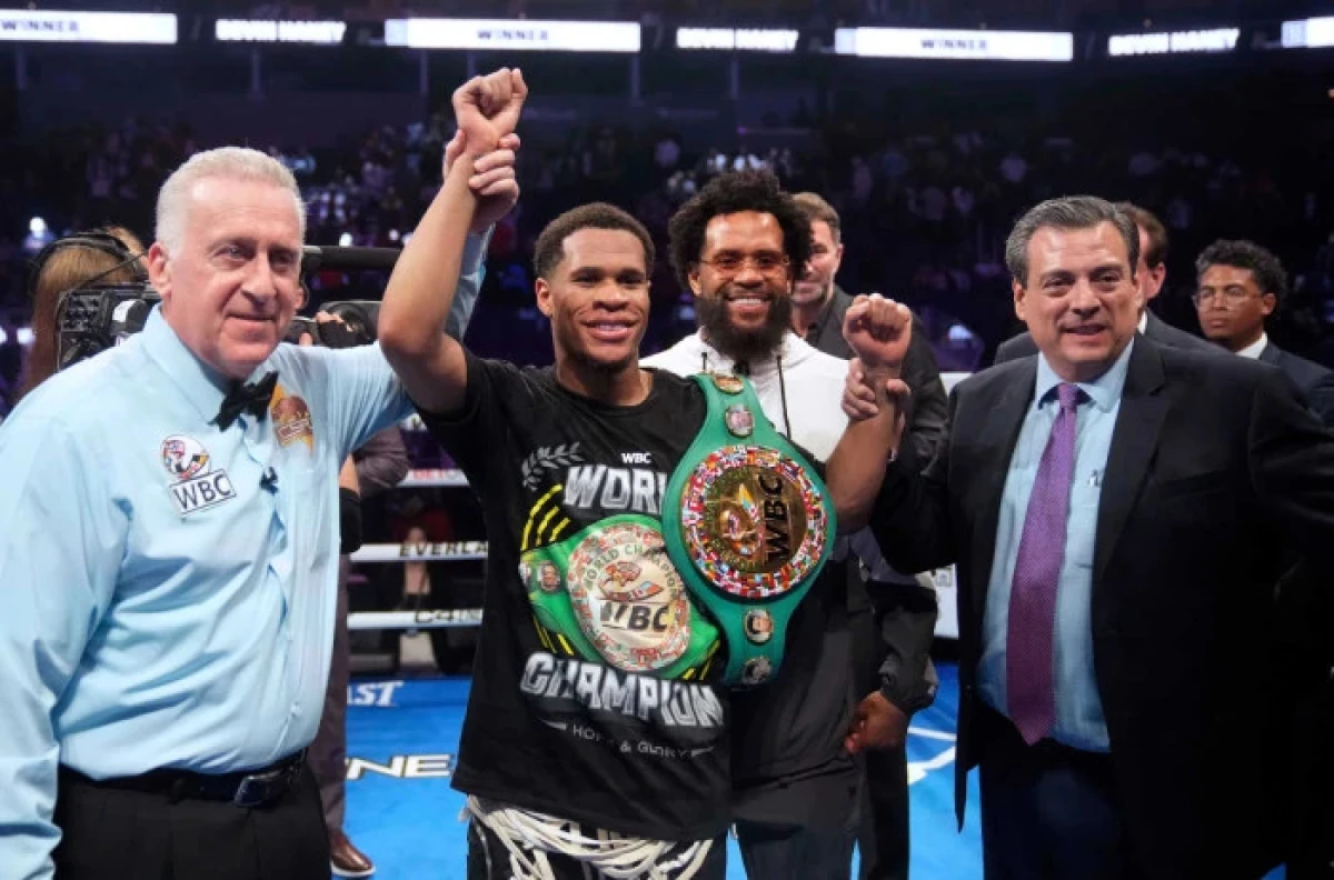 Devin Haney, center, celebrates after defeating Regis Prograis in the WBC super lightweight title boxing bout - Dec 2023