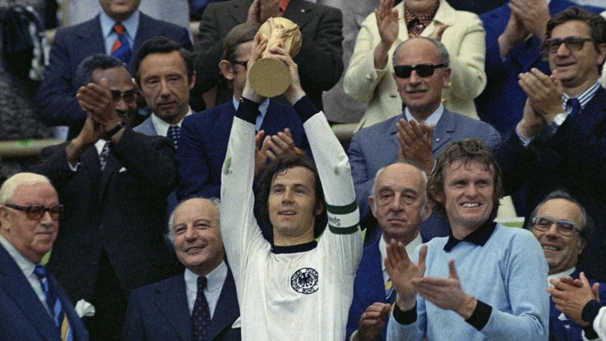 Franz Beckenbauer holds up the World Cup trophy