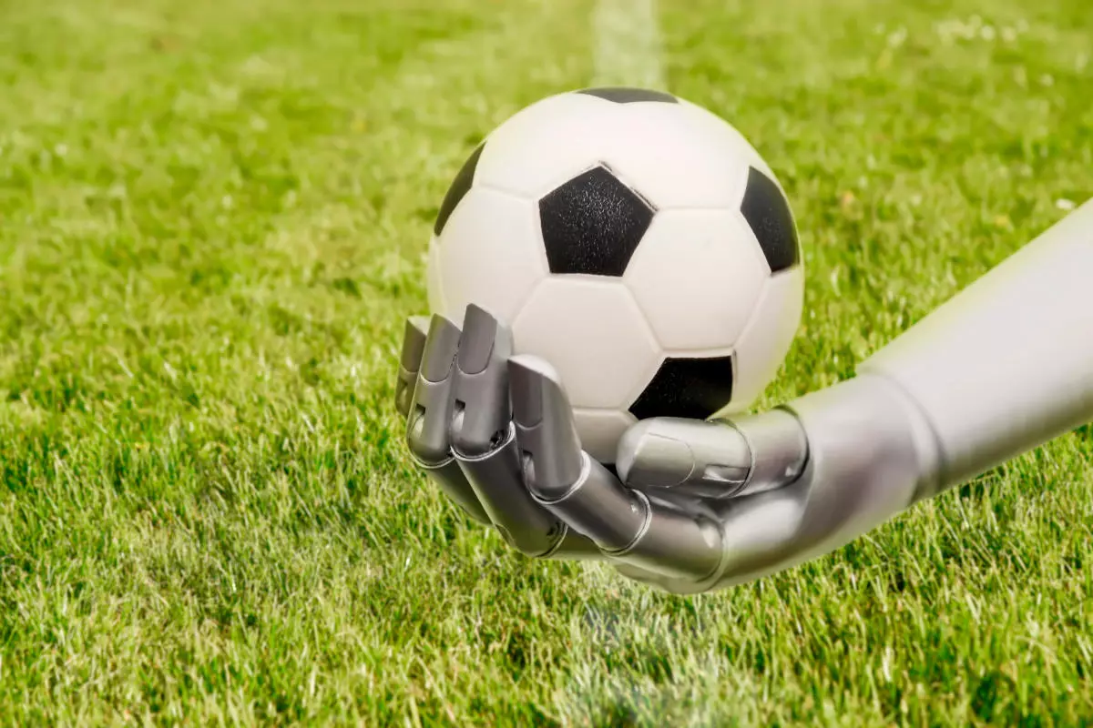 A robot arm reaches out to a football. Soccer playing with machine - Aug 2023