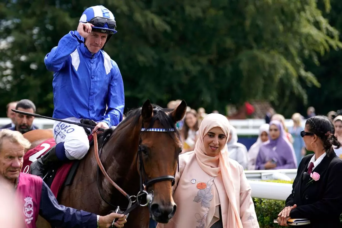 Jim Crowley celebrates winning the Qatar Nassau Stakes with Al Husn