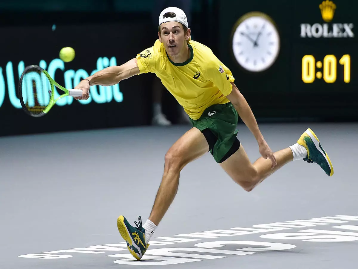 Alex De Minaur of Austalia returns the ball