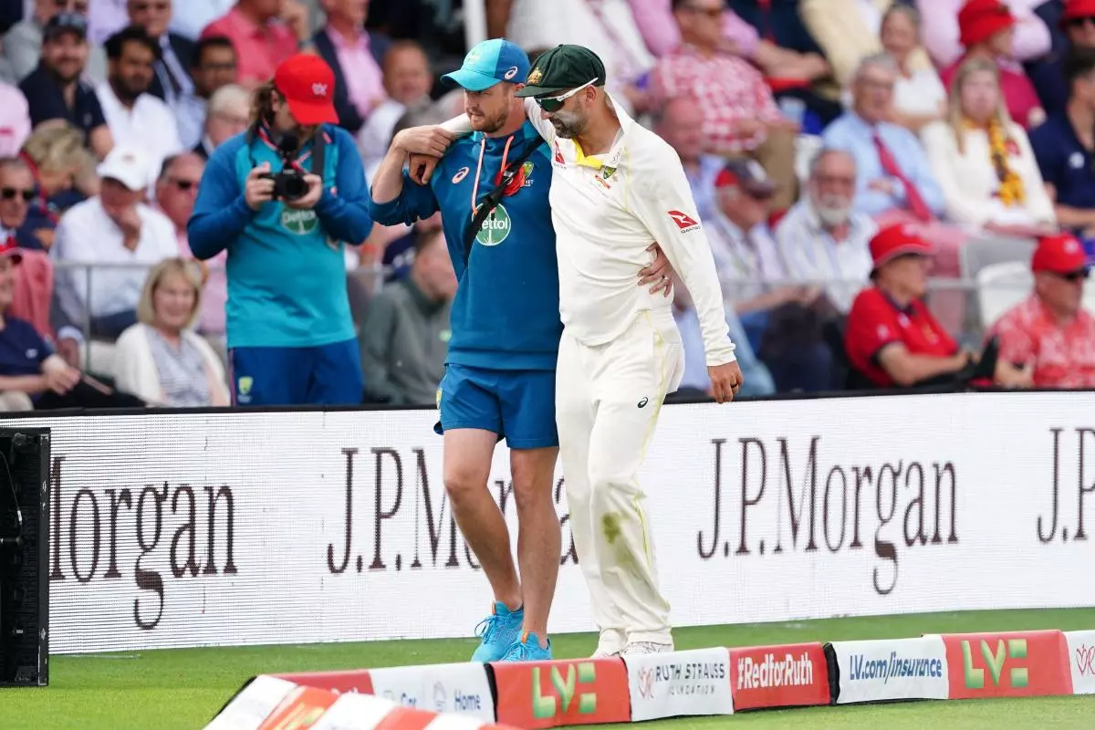 Australia's Nathan Lyon is helped from the field after picking up an injury during day two of the second Ashes test match at Lord's - June 2023