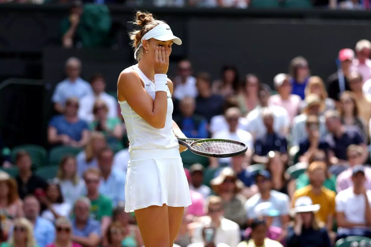 Beatriz Haddad Maia looks dejected as she retires through injury during her match against Elena Rybakina at Wimbledon - July 2023
