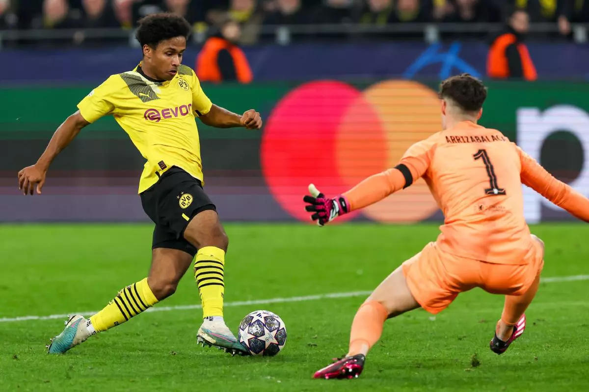 Karim Adeyemi of Borussia Dortmund on his way to score against Chelsea goalkeeper Kepa Arrizabalaga