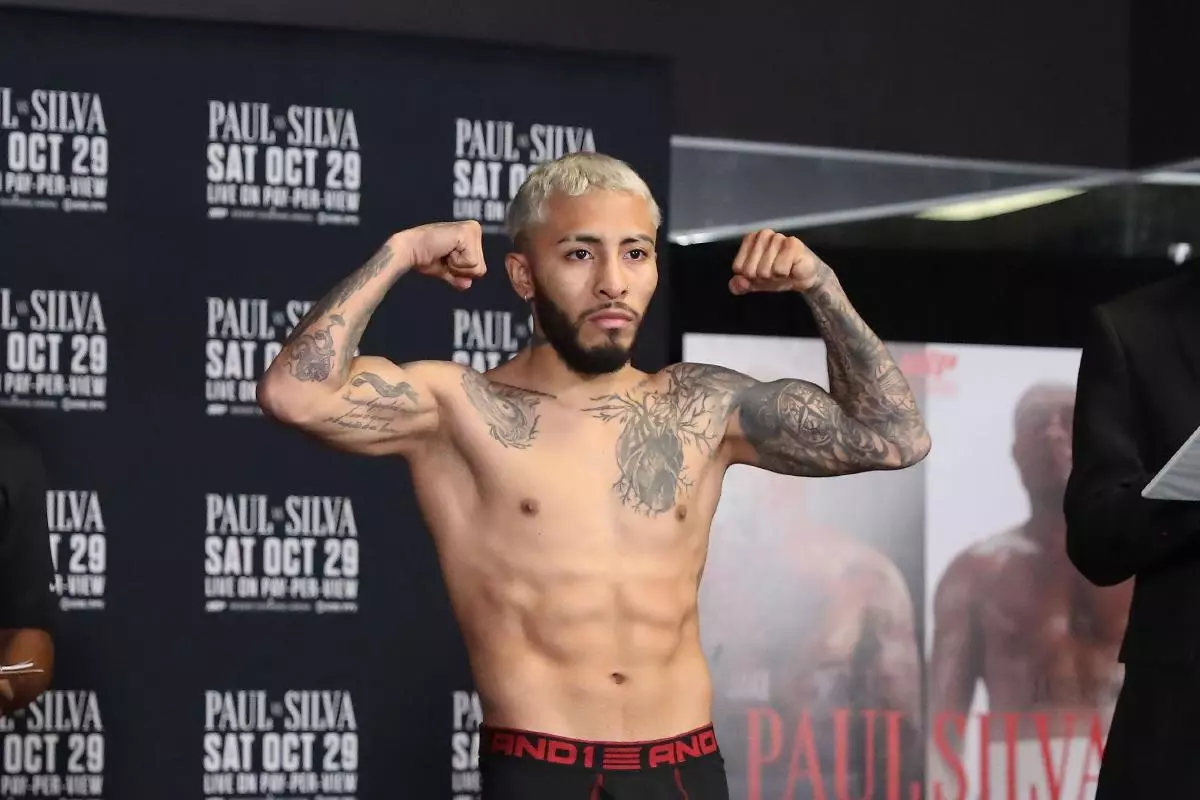 Boxer Alexandro Santiago steps on the scale during the Official Weigh-Ins - October 2022