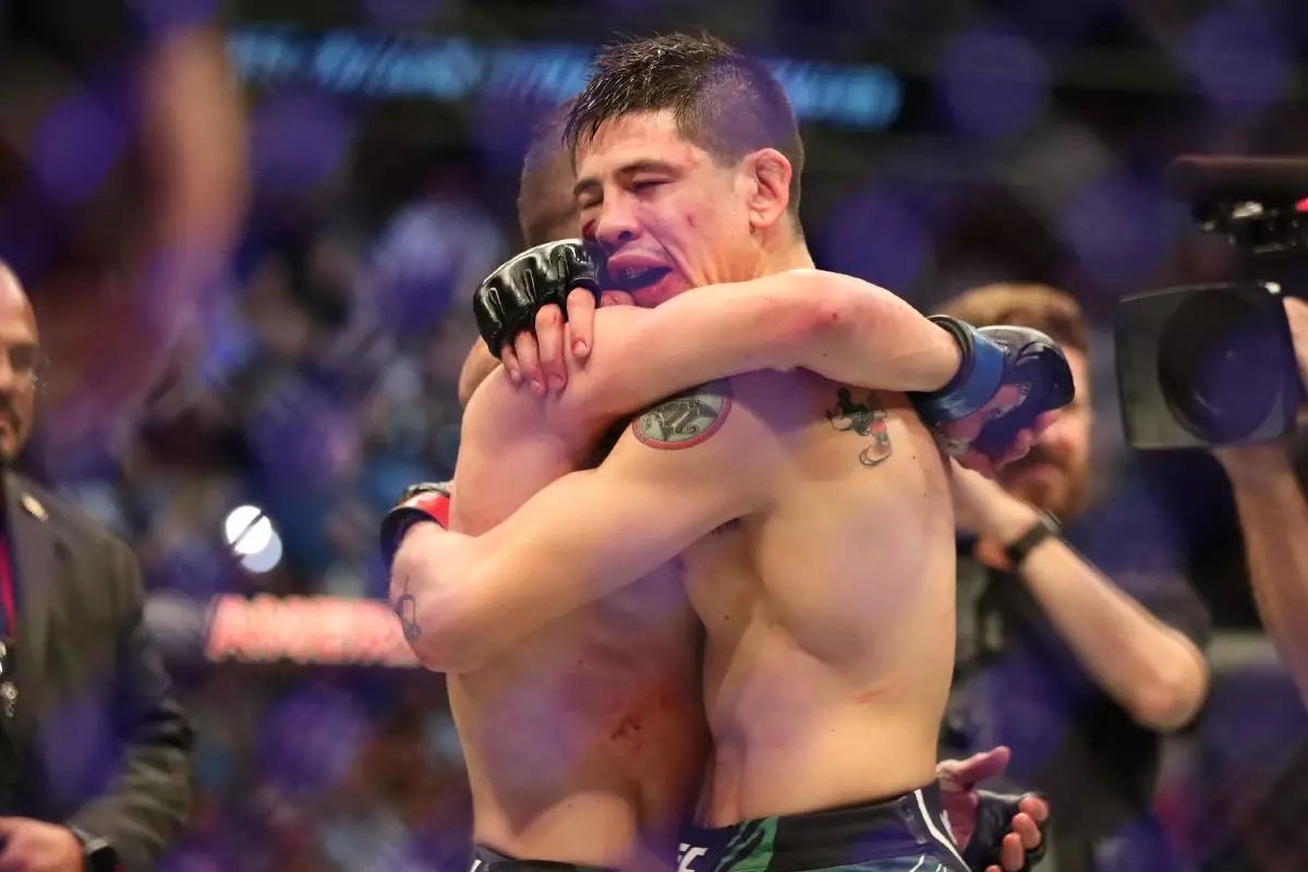 Brandon Moreno hugs Kai Kara-France after UFC 277