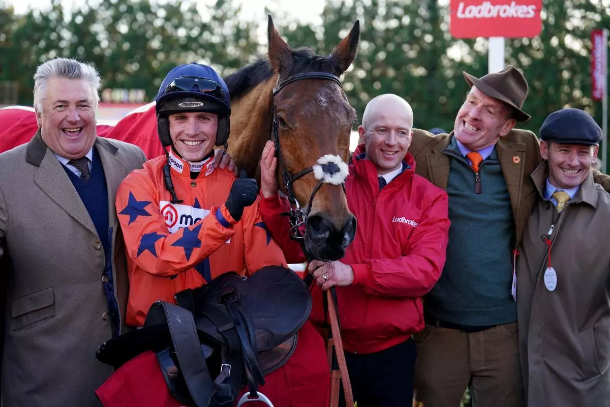 Trainer Paul Nicholls (left), Jockey Harry Cobden (centre left) and owner Bryan Drew (second right) celebrate winning The Ladbrokes King George VI Chase ridden by Bravemansgame