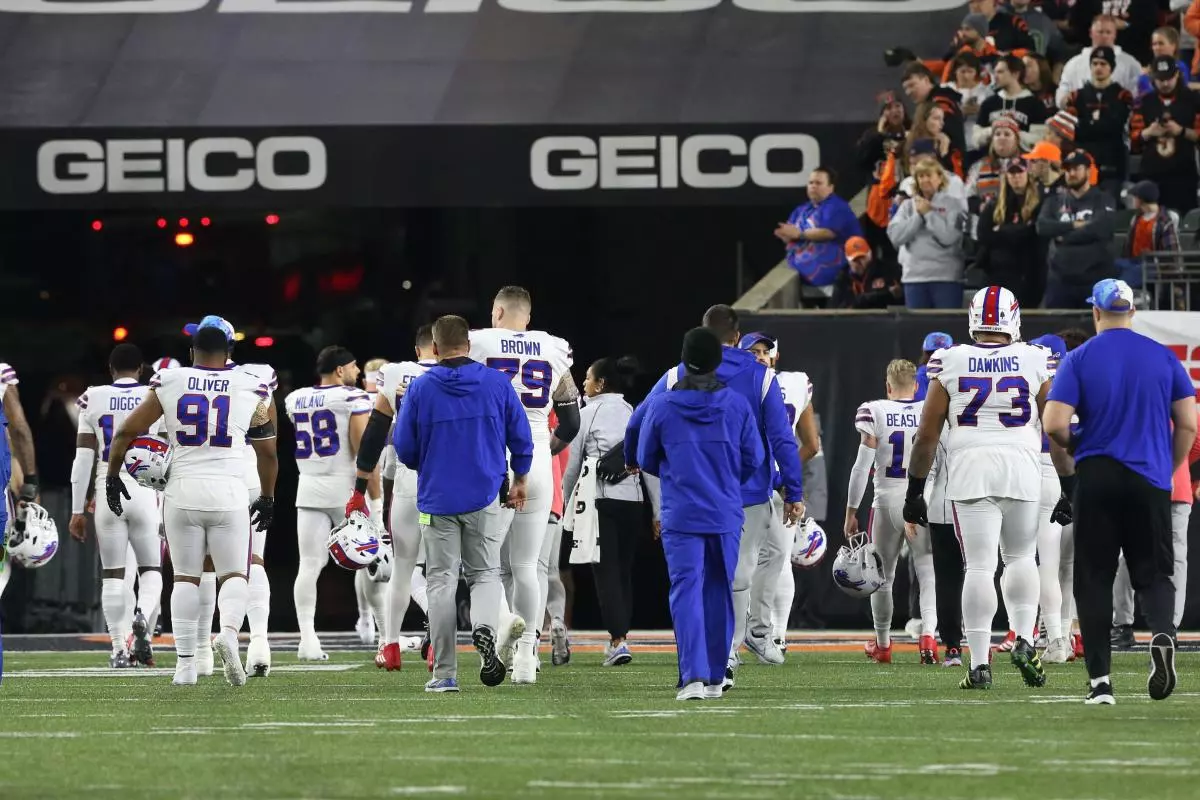 Buffalo Bills team leaves the field after teammate Damar Hamlin (3) was injured making a tackled against the Cincinnati Bengals