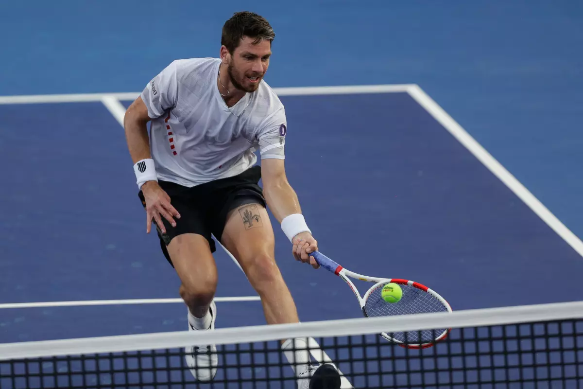Cameron Norrie of Great Britain hits a return