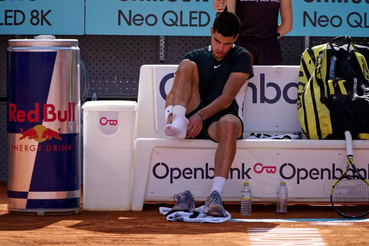 Carlos Alcaraz receives attention after an injury.