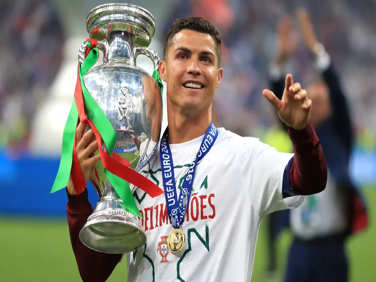 Portugal's Cristiano Ronaldo celebrates on the pitch with the trophy after Portugal win the UEFA Euro 2016 final.