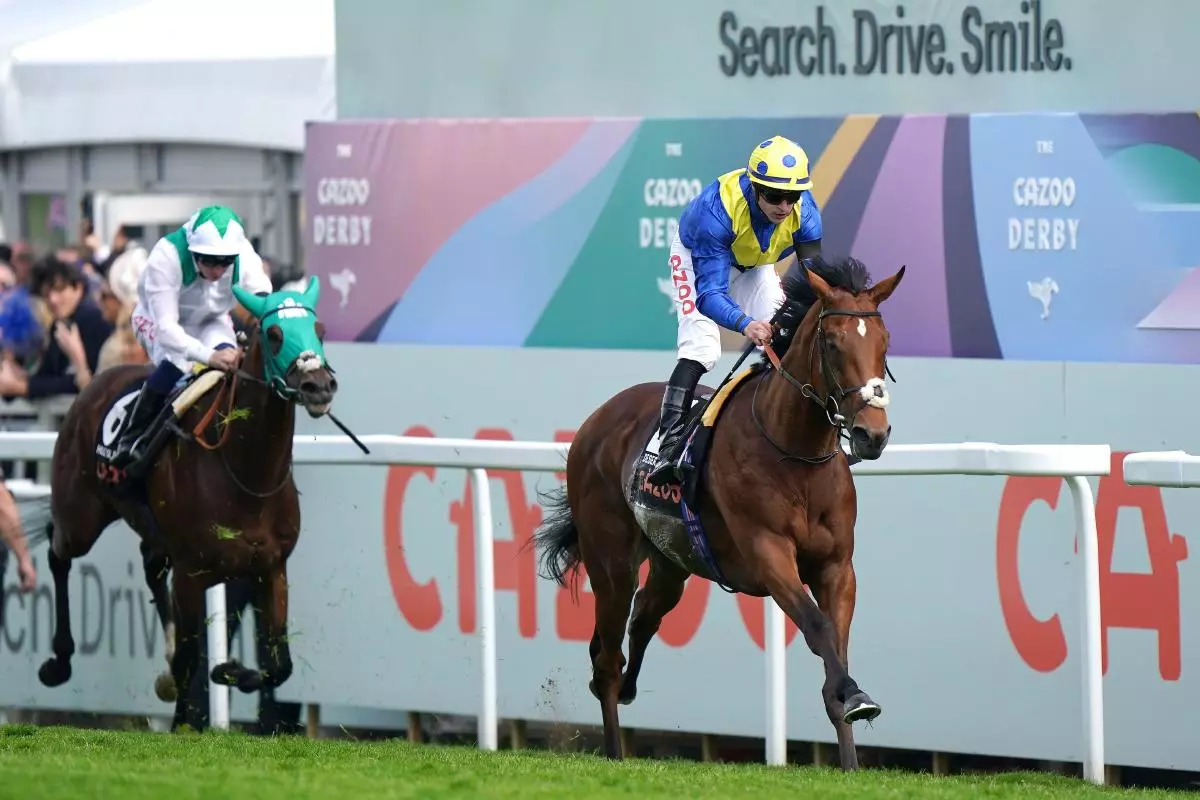 Desert Crown ridden by jockey Richard Kingscote wins the Derby