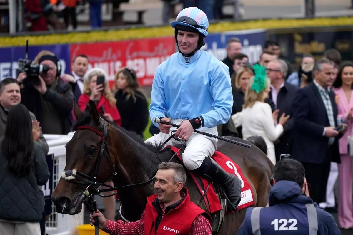 Donagh Meyler celebrates winning the Dooley Insurance Group Champion Novice Chase with Feronily
