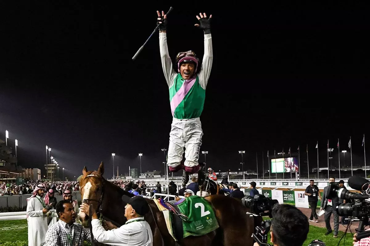 Elite Power's jockey Frankie Dettori performs his trademark flying dismount after winning the Riyadh Dirt Sprint